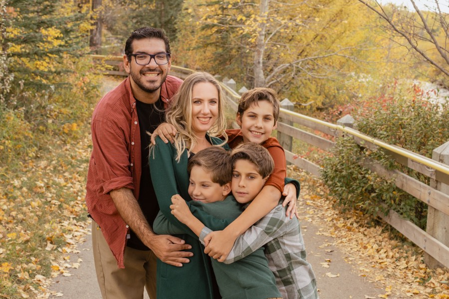 Family walking together through a golden field